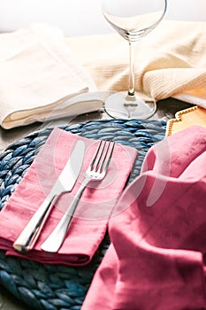 Holiday table setting with pink napkin and silver cutlery, food styling props, vintage set for wedding, event, date, party or