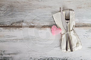 Holiday Table Setting with rose heart on gray background