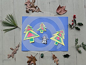 holiday themed arts and crafts for kids with colorful christmas trees and snowman