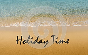 Holiday time written on tropical beach