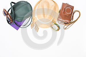 Holiday, travel background. Green cross bag, straw hat, retro brown sunglasses, retro camera, boho bracelet and earrings. Flat lay