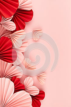 Holiday Valentine day background with flying pink and red paper folded ribbed hearts on soft light pink background as festive.