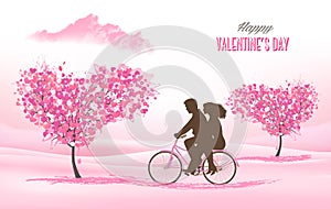 Holiday Valentine`s Day background. Couple in love on a bicycle and heart shaped tree