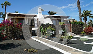 Holiday villas in Lanzarote with gardens and paths.