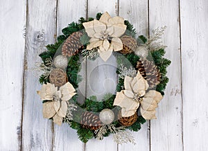 Holiday white Poinsettia Christmas wreath on rustic white wooden