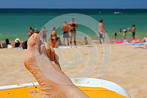 Holidaymaker relaxing on Falesia Beach in Algarve photo