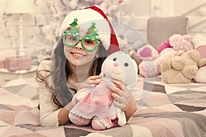 Holidays atmosphere. Christmas spirit. New year holiday. Small child wear santa hat celebrate new year at home decorated