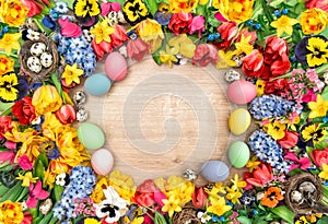 Holidays background with spring flowers and easter eggs. Tulips