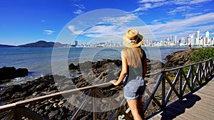 Holidays in Balneario Camboriu, Santa Catarina, Brazil. Panoramic banner view of beautiful female model looking at Balneario