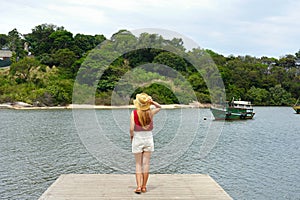 Holidays in Brazil. Full length view of tourist girl on pier in Espirito Santo, Brazil, South America