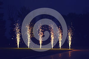 Holidays, celebration concept - many fireworks on ground over evening sky