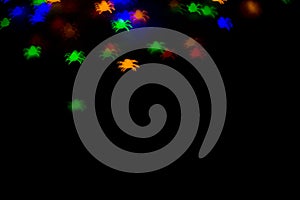 holidays, decoration and party concept - defocused bokeh multicolor lights in shape of spiders for halloween background. copy spac