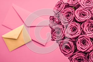 Holiday love letter and flowers delivery, luxury bouquet of roses and card on blush pink background for romantic holiday design