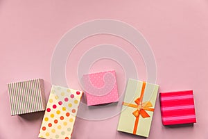 Holidays giftboxes on the pastel pink background for