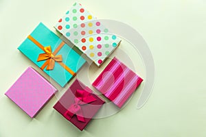 Holidays giftboxes on the pastel yellow background