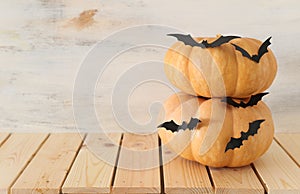 Holidays Halloween image. pumpkins and bats over wooden white table photo