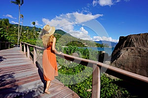 Holidays in Ilhabela, Brazil. Full length of young tourist woman on trail in Praia Pedra do Sino tropical beach in Ilhabela,