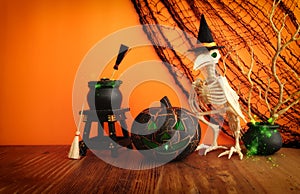 holidays image of Halloween. pumpkin and bird skeleton over wooden table