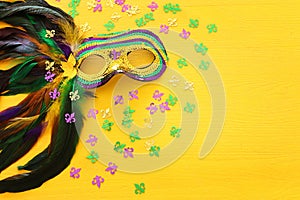 Holidays image of mardi gras masquarade venetian mask over yellow background. view from above