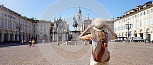 Holidays in Italy. Panoramic view of traveler girl walking in Piazza San Carlo square enjoying cityscape of Turin, Italy. Young