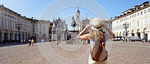 Holidays in Italy. Panoramic view of traveler girl walking in Piazza San Carlo square enjoying cityscape of Turin, Italy. Young photo