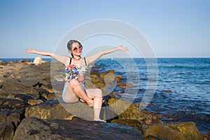 Holidays lifestyle portrait of young Asian woman by the  sea -  happy and beautiful Korean girl  enjoying beach vacation trip