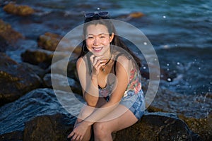 Holidays lifestyle portrait of young Asian woman by the  sea -  happy and beautiful Korean girl  enjoying beach vacation trip
