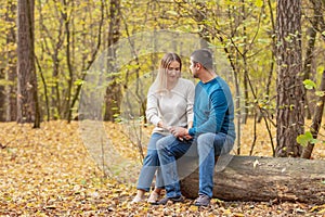 Holidays, love, tourism, relationship and dating concept - romantic couple kissing in the autumn park