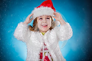 holidays, presents, christmas, childhood concept - smiling little girl over blue background.