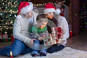 Holidays, presents, christmas concept - happy mother, father and child boy with gift box