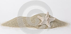 Holidays and sand beach. Close up of a starfish on the hipe of sand