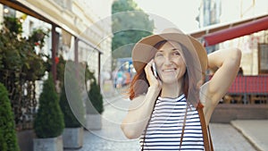 Holidays and tourism - beautiful girl with phone, tourist book and vintage camera in the city