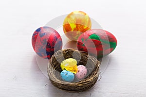 Holidays, traditions and Easter concept - Multi-colored decorative colourful eggs on white background.