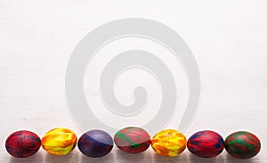 Holidays, traditions and Easter concept - Multi-colored decorative colourful eggs on white background with copy space