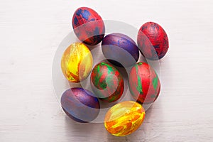 Holidays, traditions and Easter concept - Multi-colored decorative colourful eggs on white background. Top view.