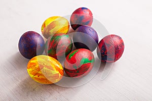 Holidays, traditions and Easter concept - Multi-colored decorative colourful eggs on white background. Top view.