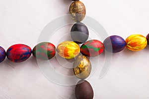 Holidays, traditions and Easter concept - Multi-colored decorative colourful eggs on white background. Top view.