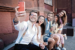 Holidays, vacation and happiness concept - group of friends taking selfie with smartphone