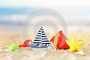 Holidays. vacation and summer image with beach colorful toys for kid over the sand