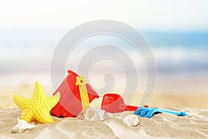 Holidays. vacation and summer image with beach colorful toys for kid over the sand