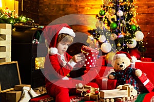 Holidays and winter childhood concept. Little boy with Christmas presents. Christmas time. Little genius. Child cheerful