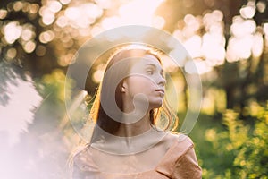 Holistic and Integrative Medicine. Mind-Body Therapies, relaxation techniques. Outdoor portrait of Young woman in nature photo