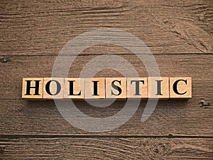 Holistic, text words typography written on wooden lettering, life and business motivational inspirational
