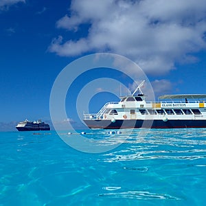 The Holland America Line Zuiderdam cruise ship anchored off the private island of Half Moon Cay in the Bahamas on a sunny day with