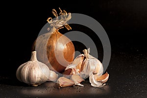 Holland Onions and galic on a black background