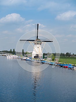 Holland rural windmill in Kinderdijk over water