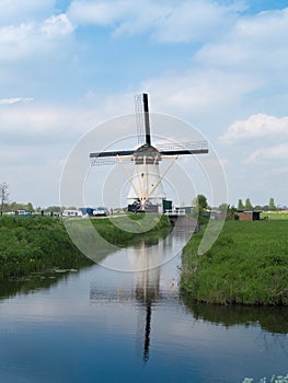 Holland rural windmill in Kinderdijk over water