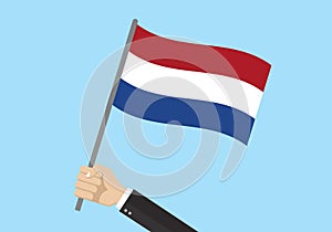 Holland waving flag. Hand holding Dutch flag. National symbol of the Netherlands. Vector illustration