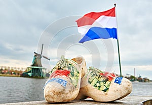 Holland. Wooden shoes netherland flag and windmill in zaanse schans