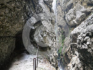 Hollentalklamm narrow Canyon - hiking in bavarian Alps near Garmisch Partenkirschien - mountain stream, rocks and hiking path